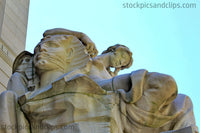 NY Statue Dramatic Figure behind Tired Woman against Blue Sky NYC