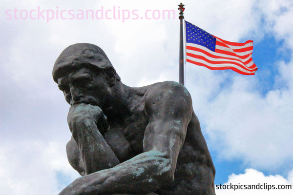 Statue The Thinker and the U.S. Flag